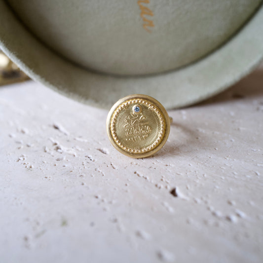 Antique gold coin and blue diamond ring