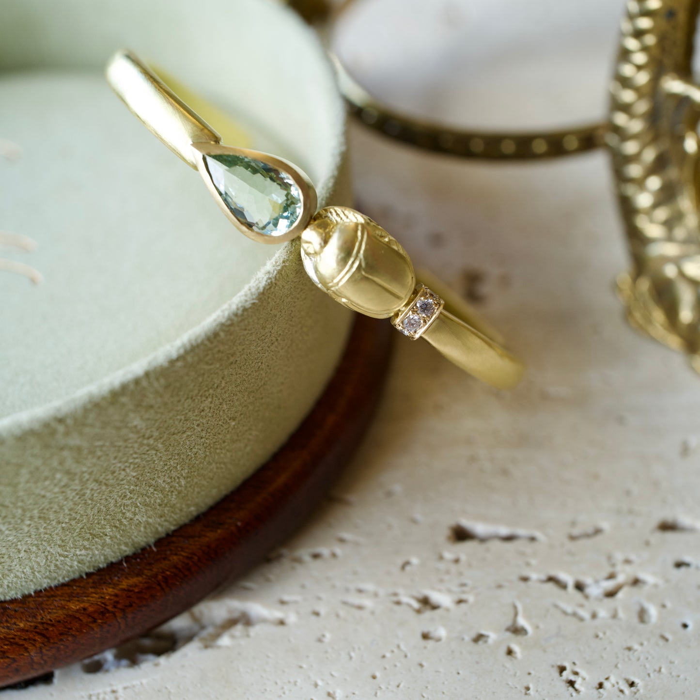 18k gold scarab cuff bracelet featuring a pear-shaped tourmaline and white diamonds.